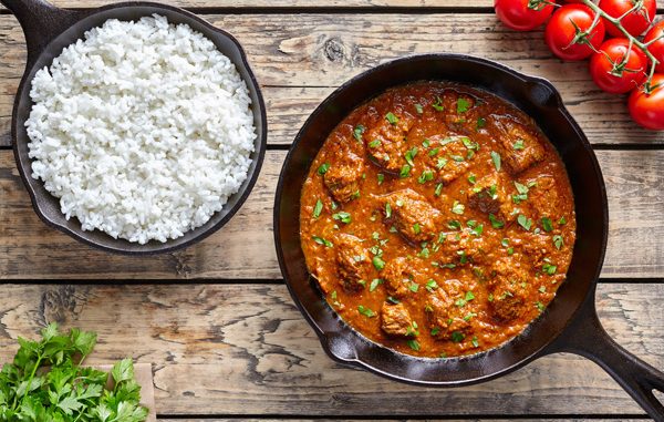 Beef Madras curry slow cook Indian spicy garam masala lamb food in cast iron pan